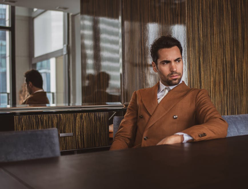 person human suit coat clothing overcoat sitting tie accessories restaurant